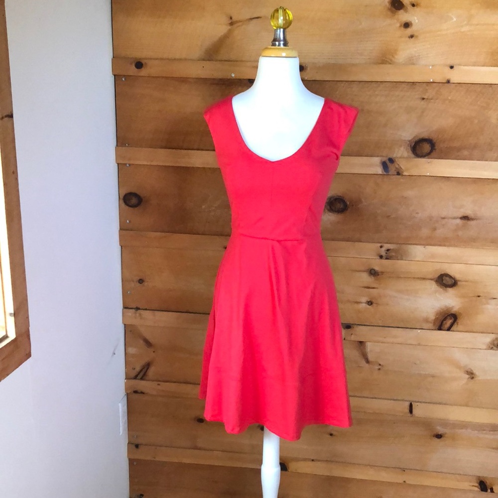 Coral colored beautifully fitting dress.
